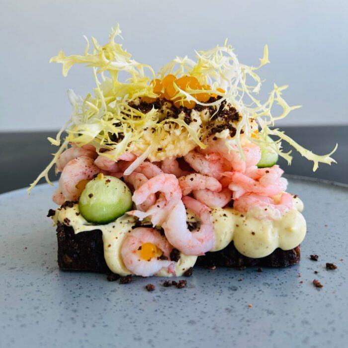 Smørrebrød med håndpillede rejer, citroncreme, agurk, æggecrumble og frisse